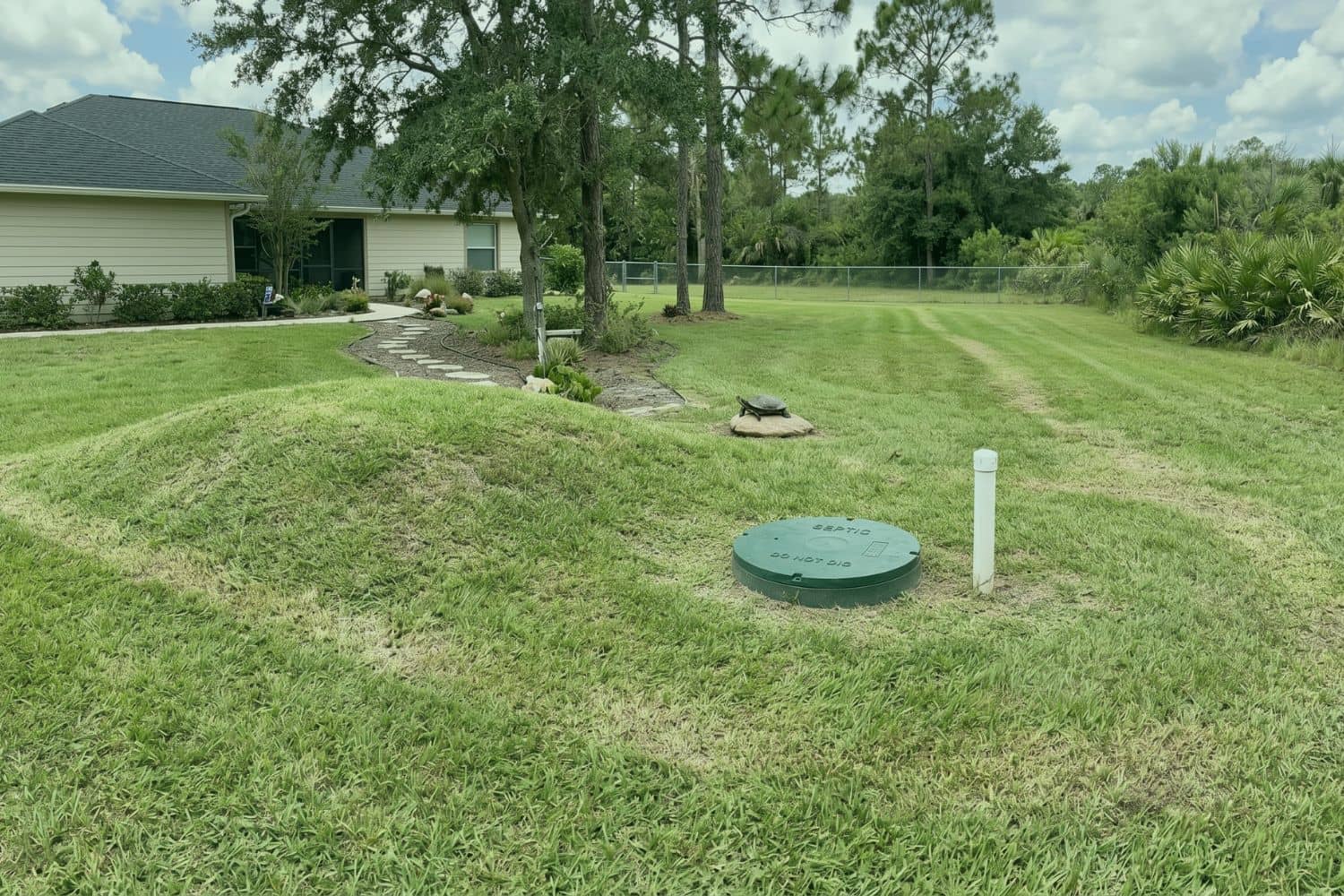 Image of a septic tank in a yard with visible signs that make it easy to find
